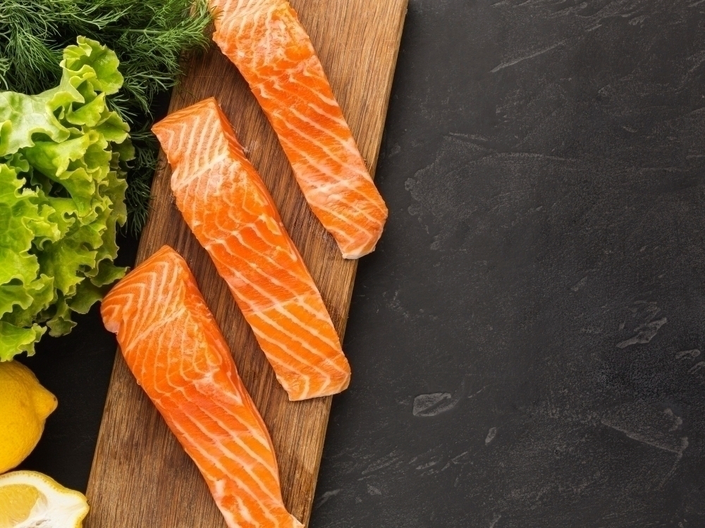 Above view salmon with omega 3 on wooden board