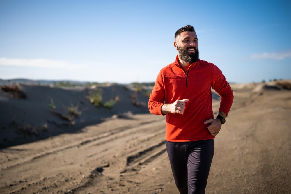 Adult man is jogging outdoor on sunny day
