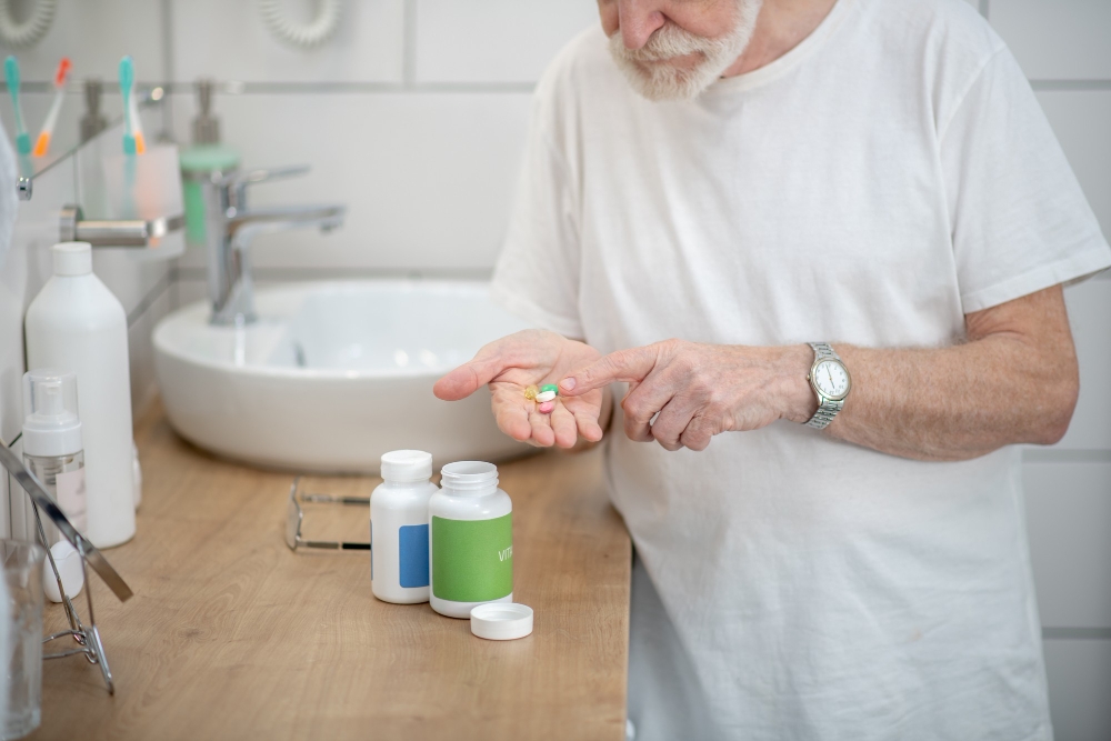 Healthcare. Man holding pills in hands getting ready to take them