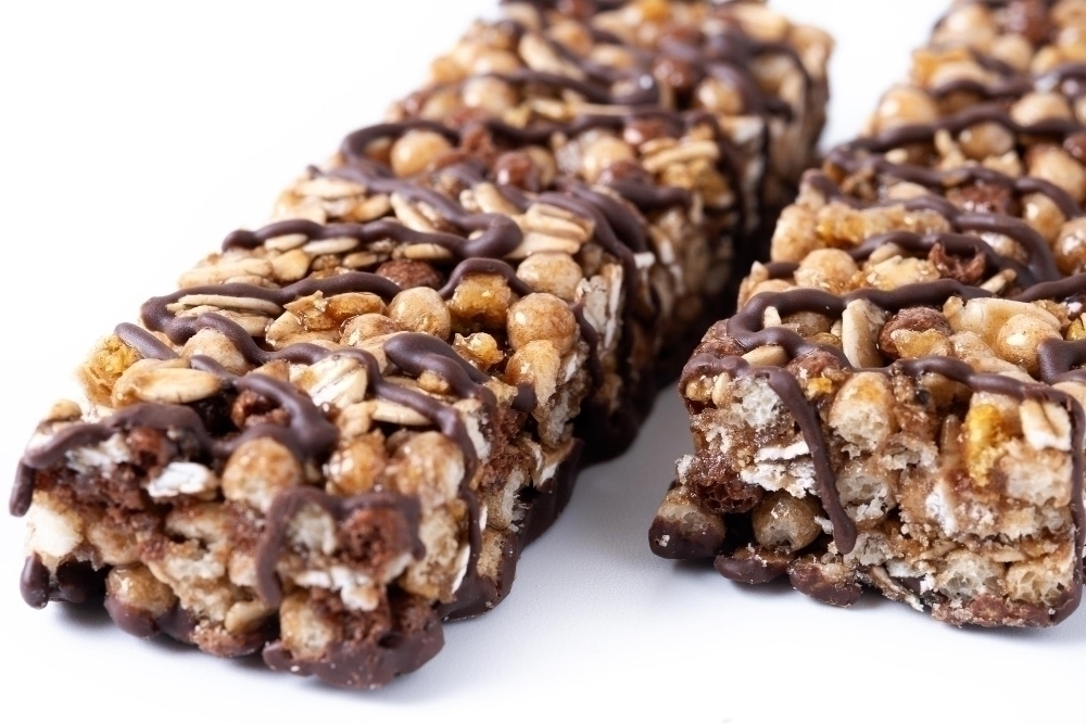 Healthy Muesli bars with nuts and black chocolate isolated on white background