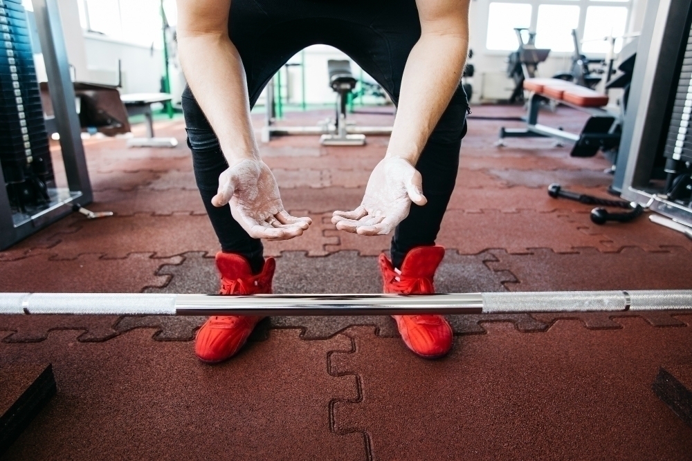 Man working out in the gym doing deadlifts needing straps