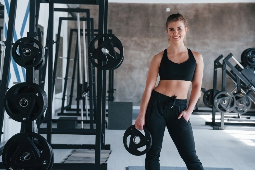 Many of equipment. gorgeous blonde woman in the gym at her weekend time