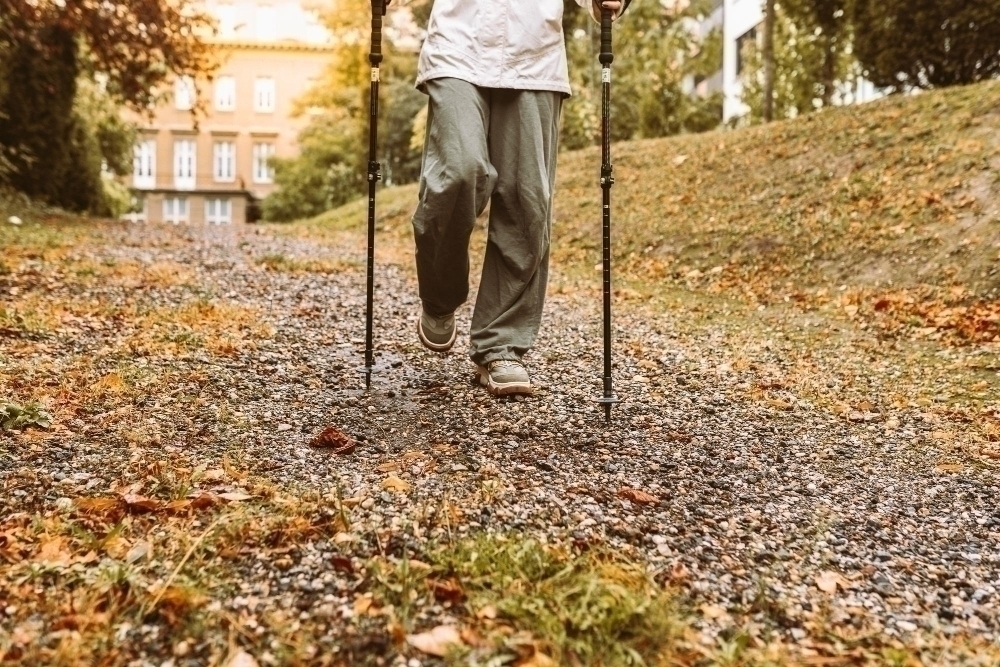 Nordic walking in autumn forest hiking teenage girl