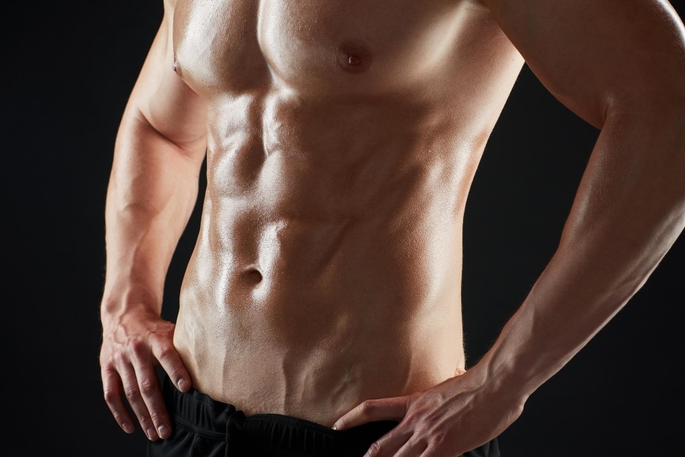 Sport bodybuilding fitness and people concept close up of young man or bodybuilder with bare torso over black background