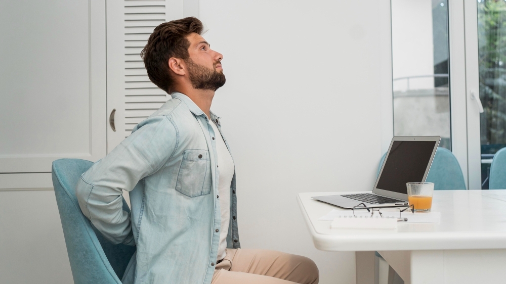 side view adult male working from home