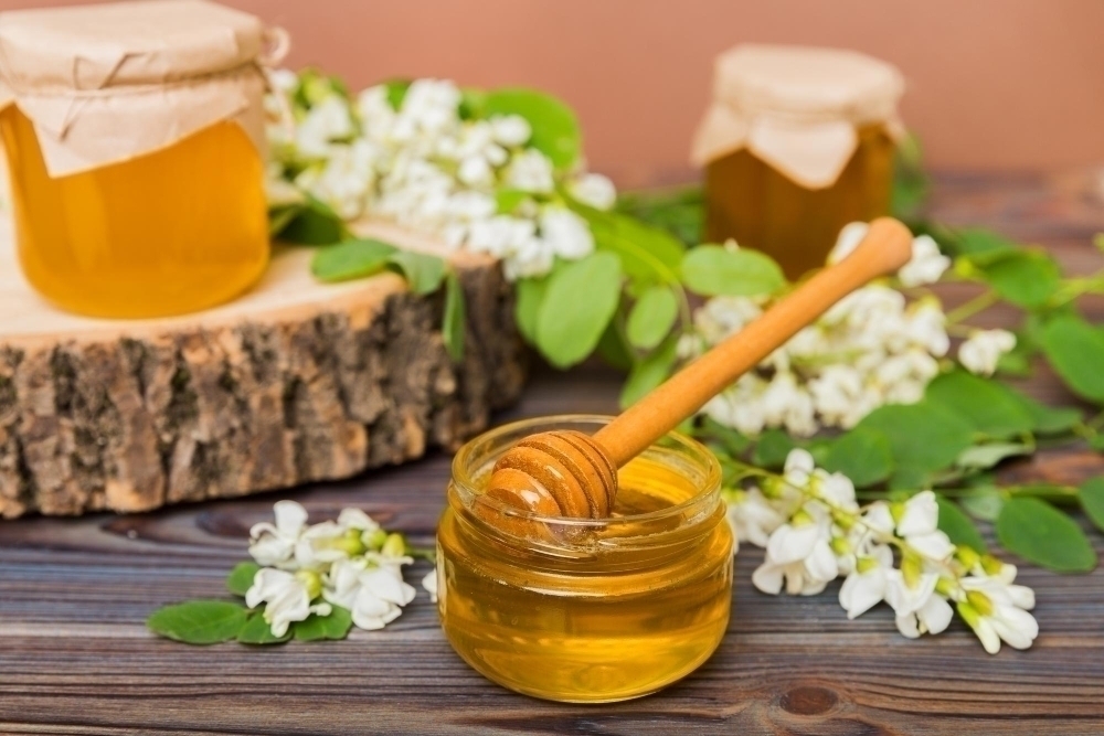 sweet honey jar surrounded spring acacia blossoms honey flows from spoon jar jars clear fresh acacia honey wooden background
