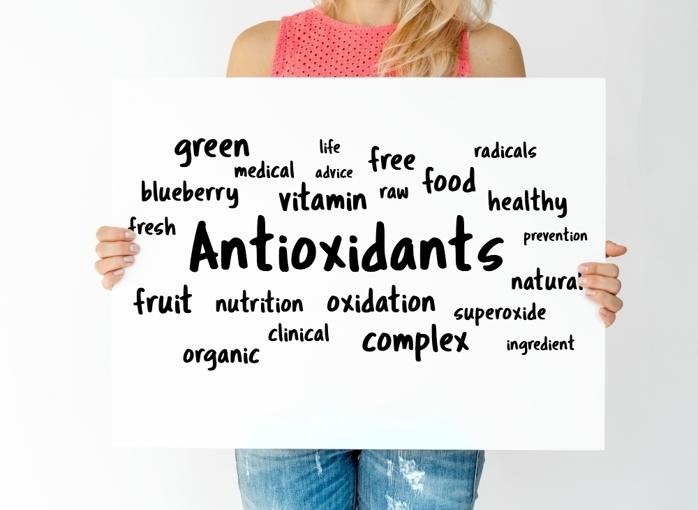 woman holding board with antioxidants concept