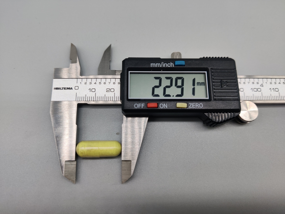 Mätning av kapselns längd med skjutmått visar 22,9 mm