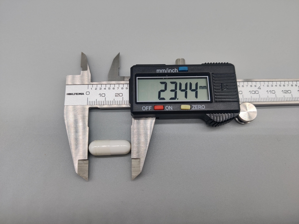 Mätning av kapsel från Core Magnesium Citrat med skjutmått 23,44 mm