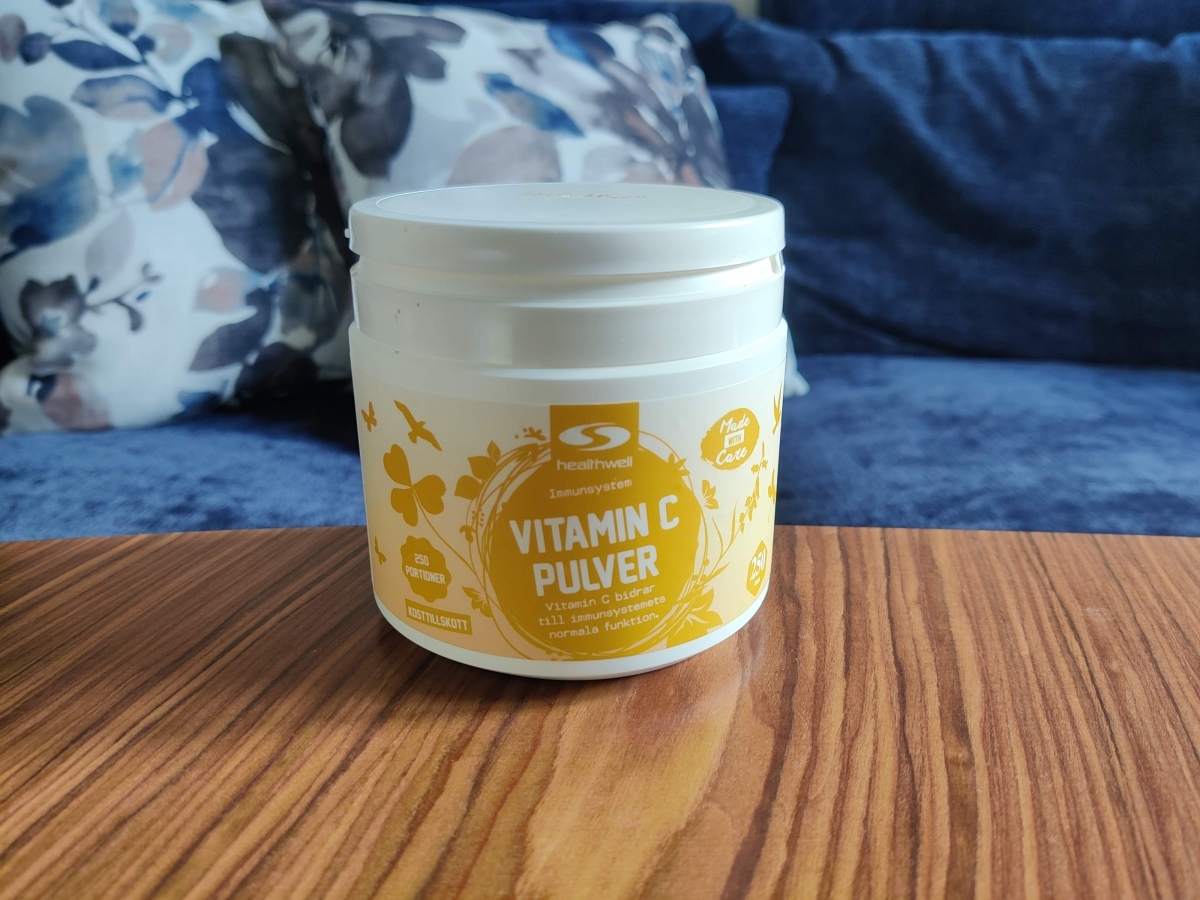 Healthwell Vitamin C Pulver i hemmamiljö på soffbordet, fotad av oss