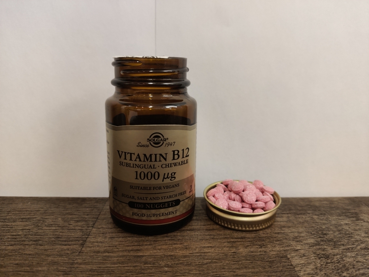Solgar B12 burk med lock intill och rosa tuggtabletter foto av oss