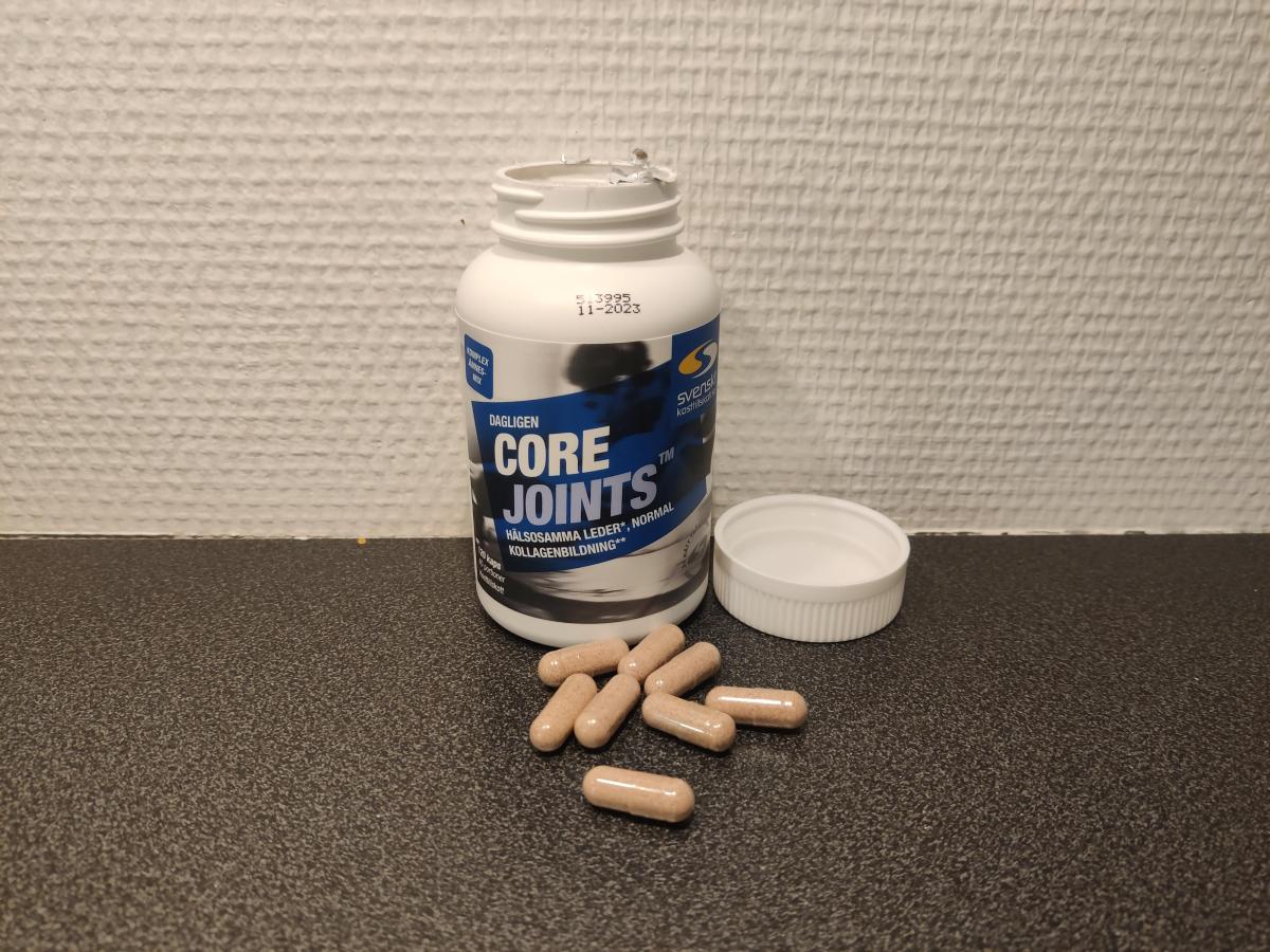 Öppen burk och kapslar av Core Joints på köksbänken foto av oss