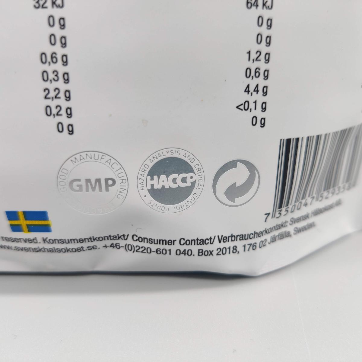 Närbild på kvalitetsmärkningar GMP och HACCP på Healthwell Detox Tea