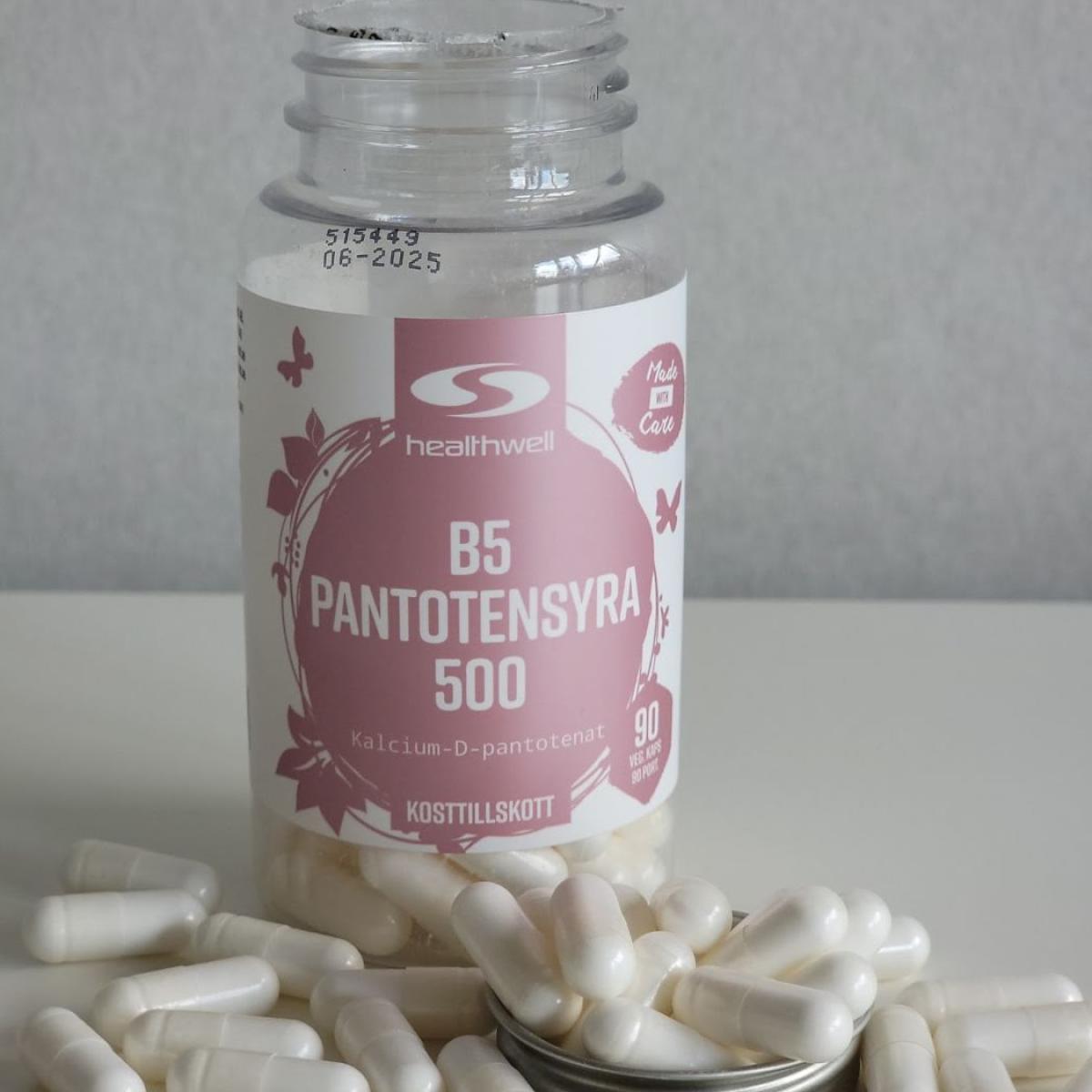Healthwell B5 Pantotensyra 500 fotograferad av oss under testet, öppen burk och kapslar på bordet