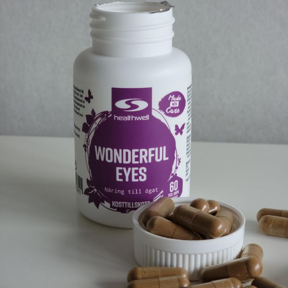 Healthwell Wonderful Eyes ovanifrån med kapslar spridda runt burken, taget av oss under testet