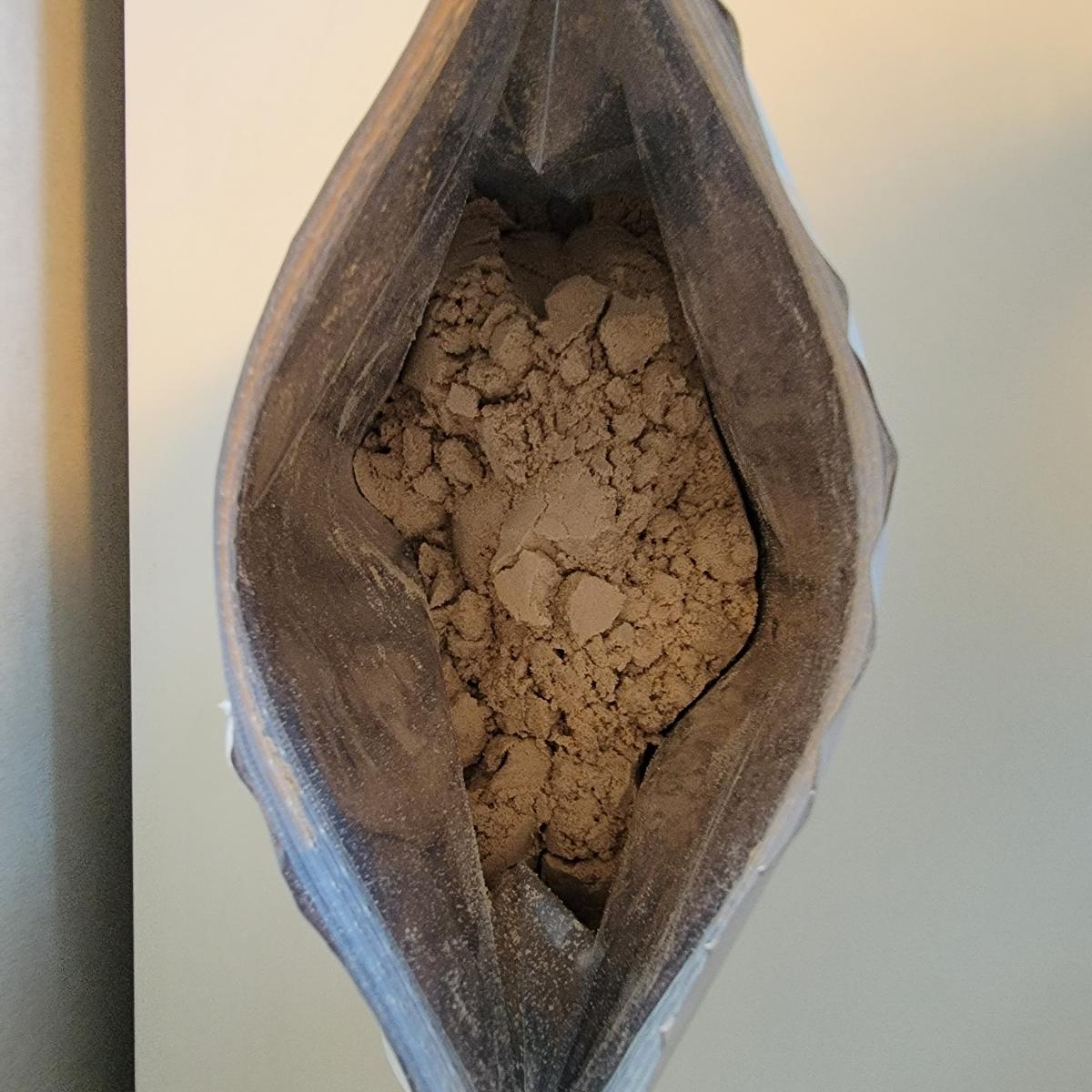 Öppnad påse Holistic Vassleprotein choklad sedd uppifrån, foto från vårt test