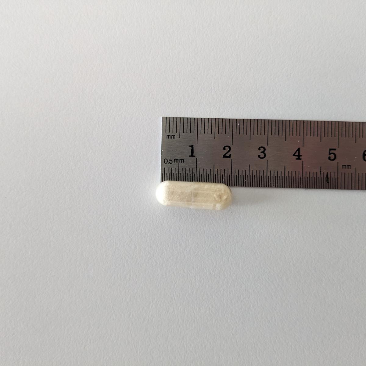 Kapsel mot linjal tagen av oss cirka 19 mm lång